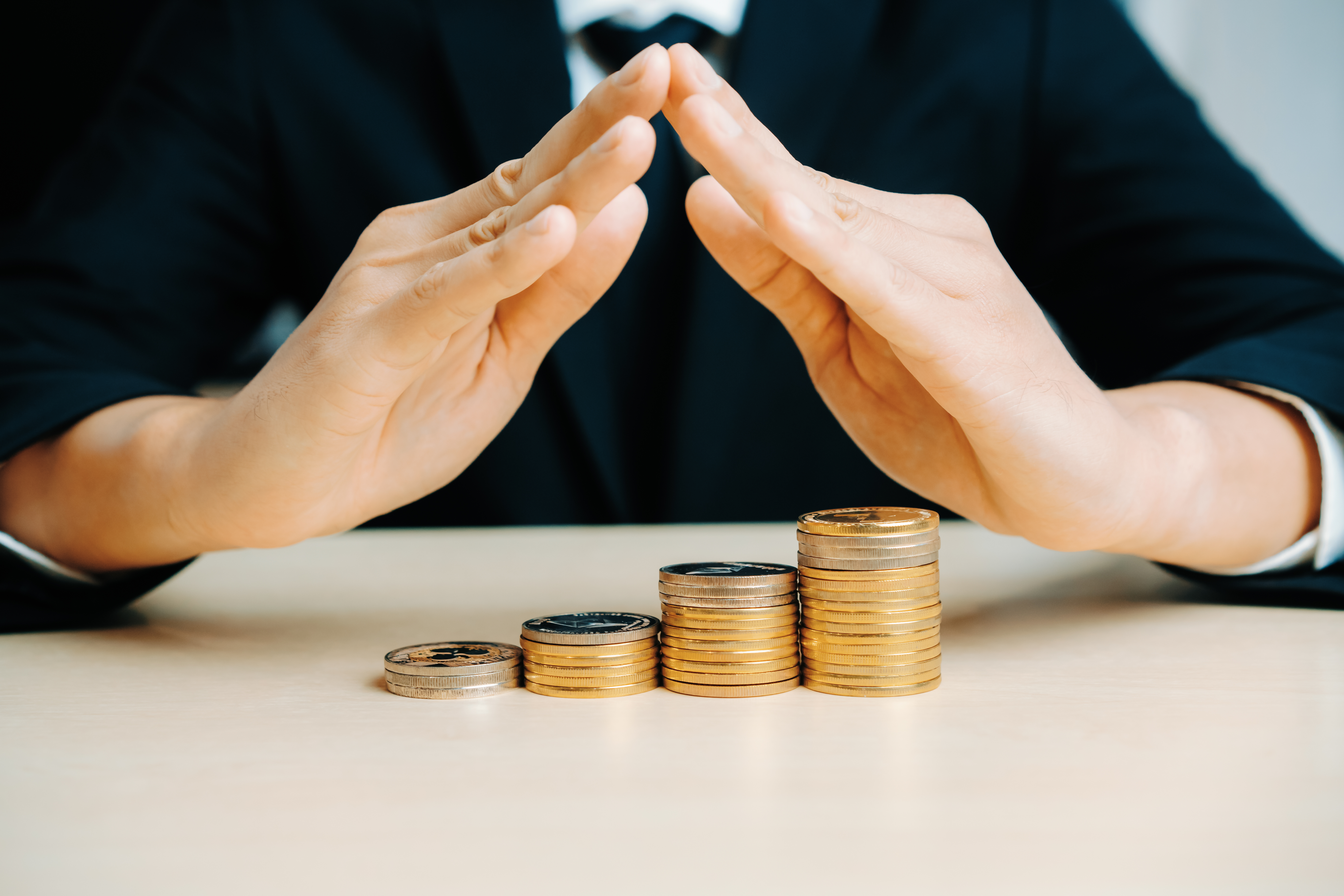 Hands protecting coins